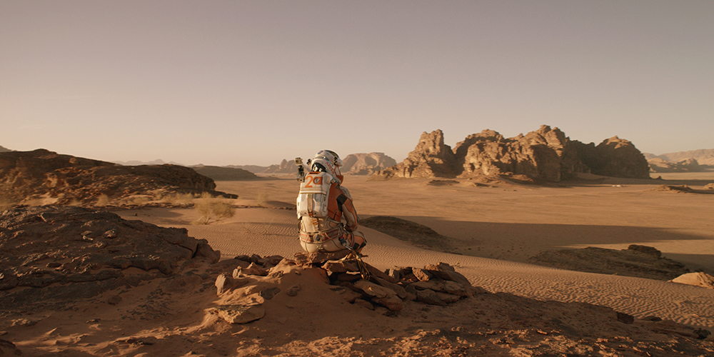 Mark Watney surveys the desolate landscape of Mars in the movie, The Martian.