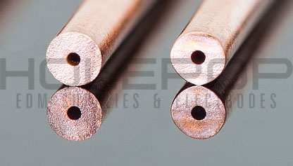A pair of copper single hole electrode tubes.