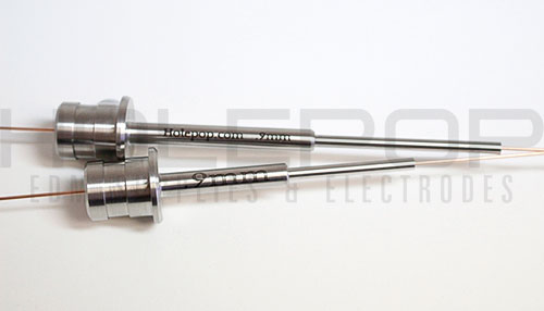 Two 9 millimeter diameter, silicon nitride, customized guides with flanged collars and hypodermic extensions.