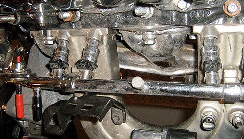 A set of fuel injectors in a car engine.